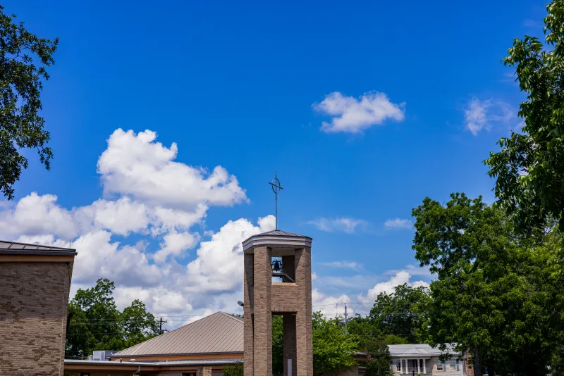 A church bell tower against a blue summer sky