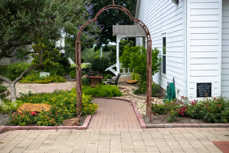 A garden archway and pathway in downtown Bastrop