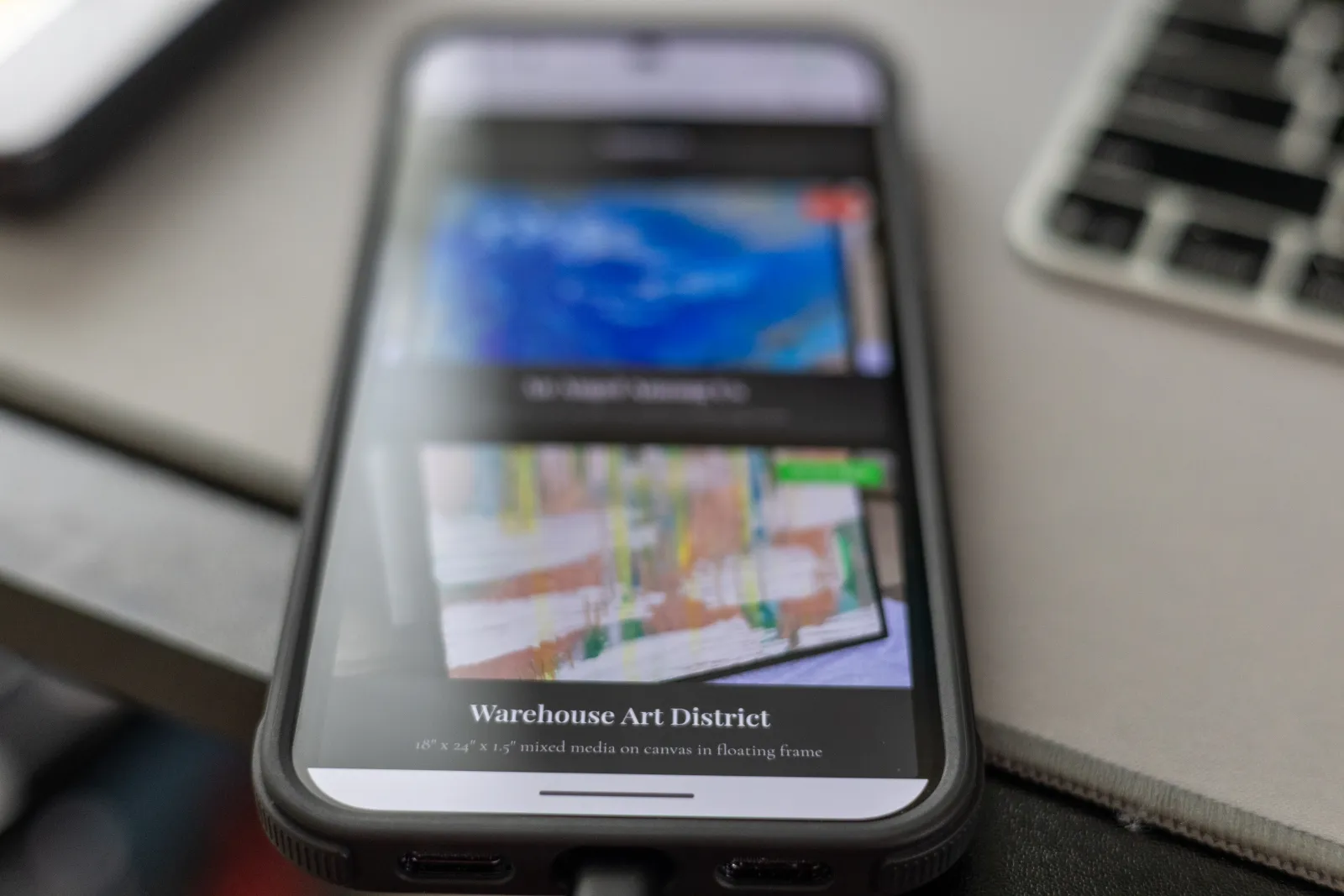 A small-business website displayed on a phone resting on a desk